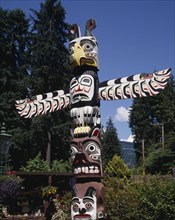 CANADA, British Columbia, Vancouver, Stanley Park a close up of the top of a Totem pole with