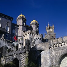 PORTUGAL, Estremadura, Sintra, Pena Palace. Building details with golden domes and flag