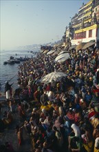 INDIA, Uttar Pradesh, Varanasi, Crowds gathered beside the River Ganges during Sivaratri Festival.