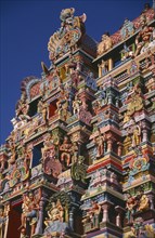 INDIA, Tamil Nadu, Madurai, Sri Meenakshi Temple detail of brightly coloured gopuram exterior wall
