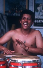 CUBA, Music, Salsa musician playing red drums with his hands