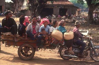 CAMBODIA, Kompong Thom, The market motorbike taxi and passengers.