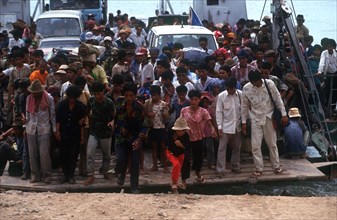 CAMBODIA, Neak Long, Crowds of people and vehicles disembarking from the Mekong ferry.