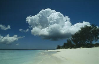 TANZANIA, Zanzibar, Mnemba Island, Beach with large cloud overhead