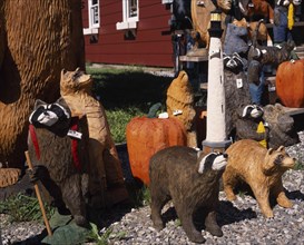USA, Vermont, Display of coloured wood carvings of various bears with pumpkins