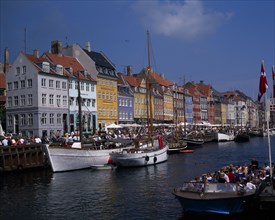 DENMARK, Zealand, Copenhagen, Nyhavn Harbour. Traditional waterfront buildings and tourists