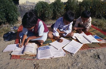 SRI LANKA, Children, Schools, "School children doing school work at a country school, outside on a