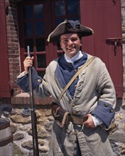 CANADA, Nova Scotia, Cape Breton Island, Fortress of Louisbourg with a smiling costumed soldier