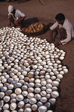 INDIA, Kerala , Varkala , Men preparing copra or dried coconut.