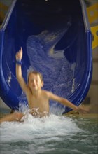 10049447 CHILDREN Leisure Swimming Boy sliding down waterchute