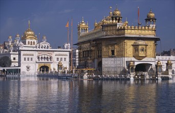 INDIA, Punjab, Amritsar , The Golden Temple reflected in surrounding pool.