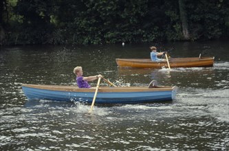 10045574 SPORT Water Sport Rowing Two boys in wooden boats competing in rowing race on the River Thames