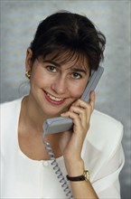 COMMUNICATIONS , Phone, Using, Businesswoman using telephone in office.