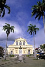 WEST INDIES, Guadeloupe, Grande-Terre, Church in small square in Pointe-a-Pitre with coconut palm