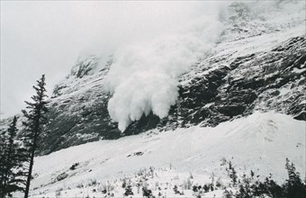 FRANCE, French Alps, Trois Vallées, Avalanche of snow crashing down steep mountainside.