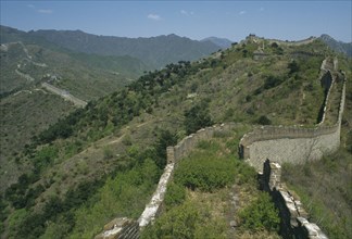 CHINA, Mutianyu, The Great Wall, View along the crumbling wall leading over hills in to the