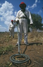 MOZAMBIQUE , Dombe , Mine Clearance workers holding metal detector.