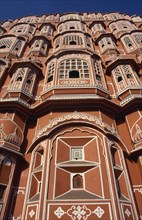 INDIA, Rajasthan, Jaipur, Hawa Mahal or Palace of the Winds. View looking up at the pink facade of