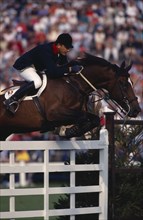 10038996 SPORT  Equestrian Show Jumping  French rider Herve Godignon competing in the 1993 Hickstead Derby  clearing white gates on bay horse.
