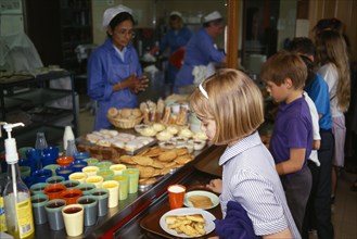 FOOD, Children, School Canteen, Dinner Lady serving lunch to shool kids.