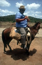 CUBA, Holguin, Rancher on horseback