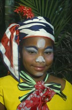 JAMAICA, Carnival, Head and shoulders portrait of girl in costume and face paint.