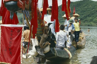 CHINA, Guizhou Province, Celebrations, Dragon Boat festival.  View along decorated boat with live