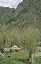 CHINA, Xinjiang, Tanchi, Kazak Yurt. Tent house with family outside
