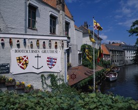 BELGIUM, West Flanders, Bruges, "Boat house with a sign for excursions, Different countries flags
