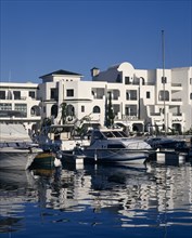 TUNISIA, Port El Kantaoui , View across the marina towards white apartment buildings.