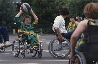 10036830 SPORT Ball Games Basketball Young physically disabled adults playing wheelchair basketball.
