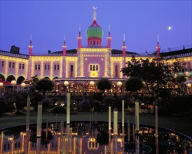 DENMARK, Zealand, Copenhagen, Tivoli Gardens buildings illuminated at night