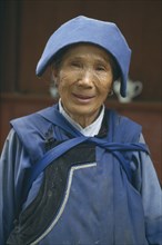 CHINA, Yunnan, Baisha, Naxi lady in traditional blue clothes