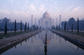 INDIA, Uttar Pradesh, Agra, The Taj Mahal exterior reflected in watercourse through formal gardens