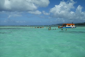 WEST INDIES, Tobago, Buccoo Reef, The Nylon Pool with tourists swimming or standing in shallow