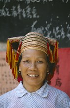 CHINA, Guangxi, Sanjiang, Dong lady  with gold teeth wearing traditional head-dress