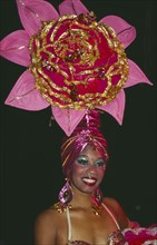 CUBA, Havana Province, Havana, Tropicana Club female dancer in pink costume with pink head-dress in