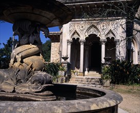 PORTUGAL, Estremadura, Sintra, Monserrate Palace .Courtyard fountain in foreground entrance beyond