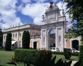PORTUGAL, Estremadura, Sintra, Seteasis Palace. View across garden towards arched gateway