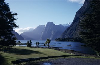NEW ZEALAND, South Island, Milford Sound, View  across water with mountains behind.