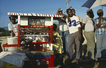 WEST INDIES, Jamaica , Markets, Men standing at drinks vendor stall.