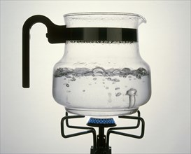 WATER, Evaporation, Steam rising from water boiling in a glass jar on a gas ring