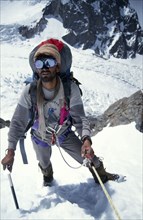 10029912 SPORT Climbing Mountaineering Pakistan.  Porter climbing to camp 1 on K2.