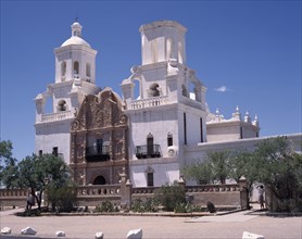 USA, Arizona, Tuscon, San Xavier del Bac Mission. White-washed building with  towers an ornate