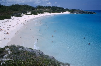 BERMUDA, Southampton, Horseshoe Bay, View over bay lined by sandy beach and vegetation with people