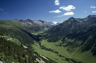 SPAIN, Pyrenees, Catalonia, Aran Valley.  River valley landscape with road following the course of