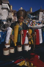 CHINA, Tibet, Lhasa, Prayer flag vendor at Jokhang Temple