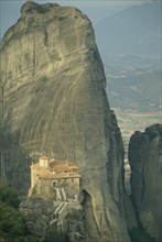 GREECE, Central Greece, Meteora, Roussanou Monastery with large rock formation behind.