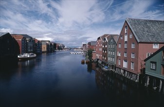 NORWAY, Sor Trondelag, Trondheim , Wharf area. Traditional wooden waterfront buildings with bridge