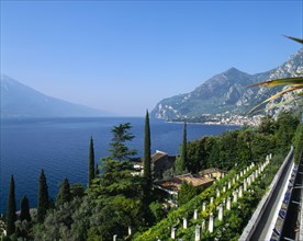 ITALY, Lake Garda,  Limone, "View over roof tops to lake, town to far right, distant hills, blue